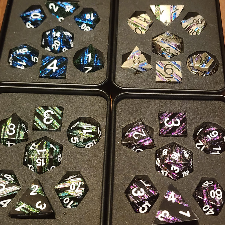 Four Dwarven Citadels striped metal dice sets in padded boxes