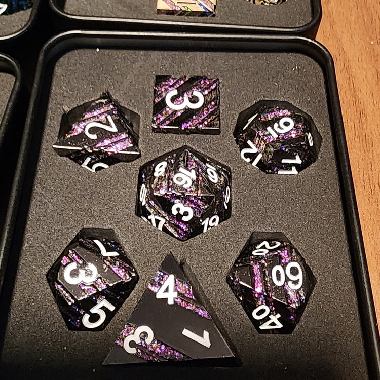 Amethyst Hall black and purple striped seven-piece metal dice set in a padded box