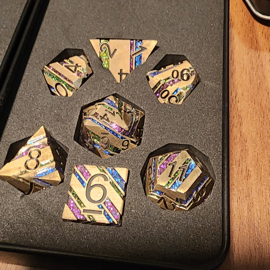 Kingsvault gold and rainbow striped seven-piece metal dice set in a padded box