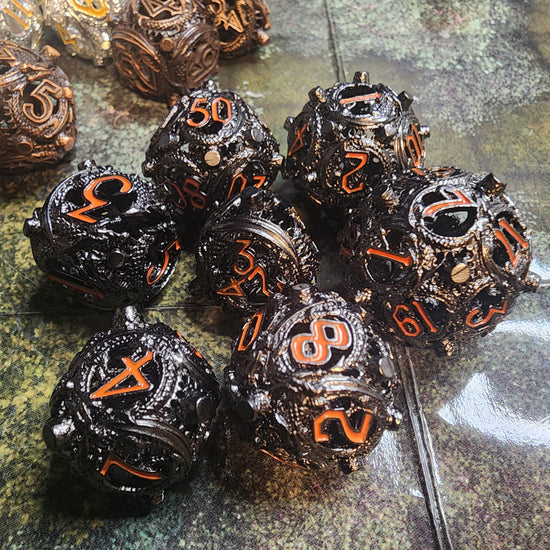 Black and orange hollow metal dice set with raised corner studs