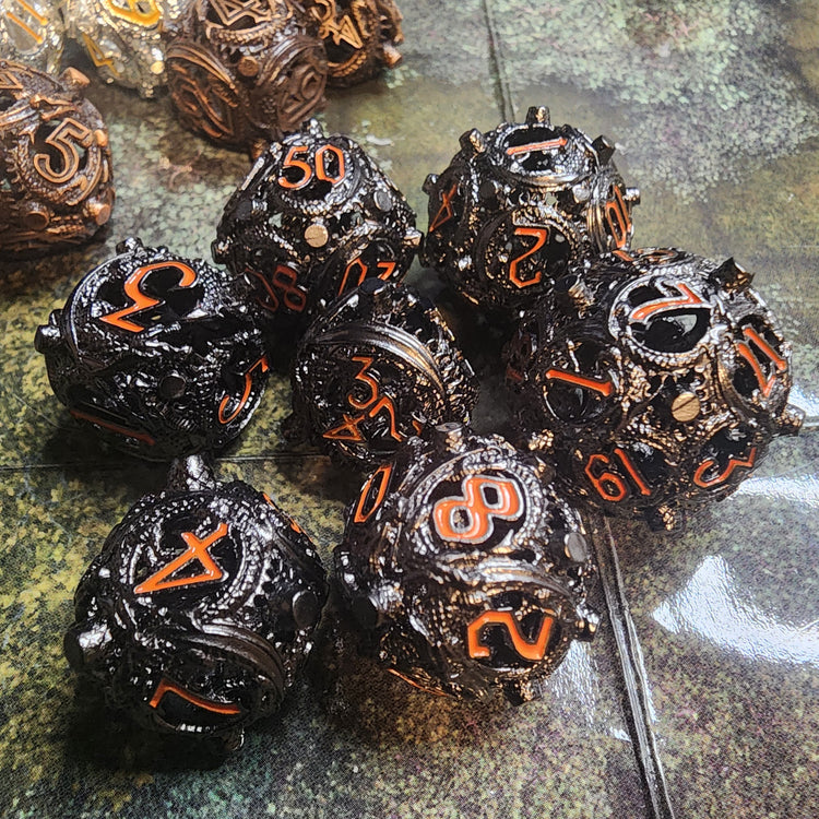 Black and orange hollow metal dice set with raised corner studs