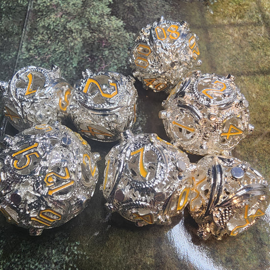Silver and gold hollow metal dice set with openwork faces
