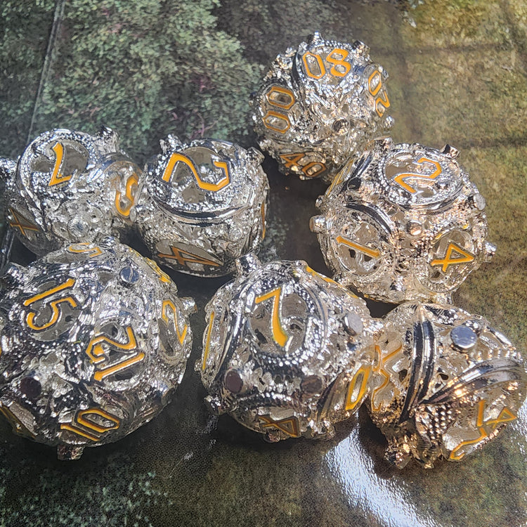 Silver and gold hollow metal dice set with openwork faces