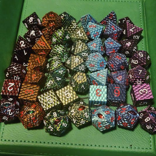 The Seven Wyrms dragon scale metal dice sets in seven colors