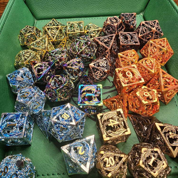 Alternate group view of hollow metal dragon dice arranged by finish