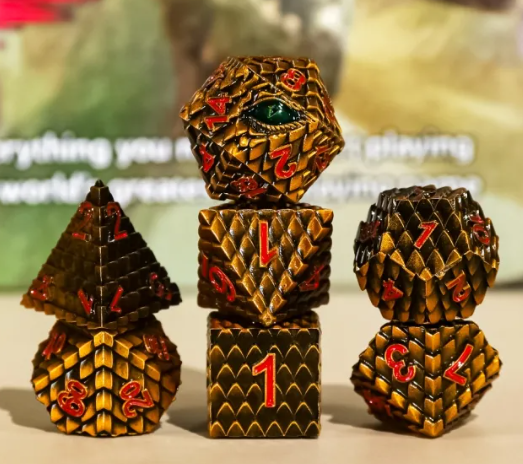 Aurvax, the Gilded Hunger Orange Yellow seven-piece metal dragon scale dice set with dragon-eye D20