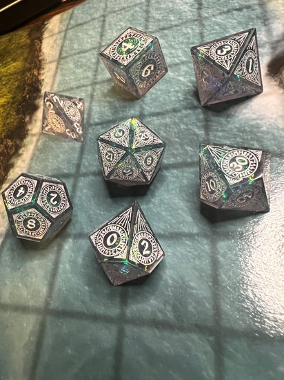 Close view of decorative circular numbering and reflective inclusions in resin RPG dice