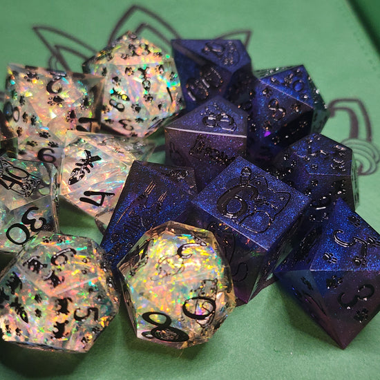 Clear iridescent and dark blue purple cat dice variations together