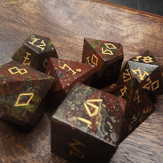 Dragonblood Jasper polyhedral dice showing red stone and green patches