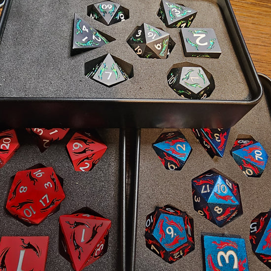 Three dagger dice finishes displayed in foam-lined boxes