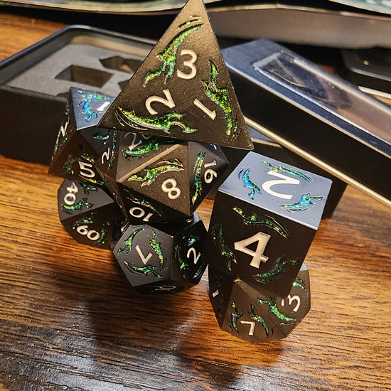 Gunmetal metal dice with shimmering green dagger motifs