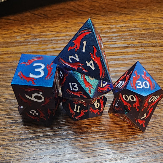 Blue metal dice with red dagger motifs
