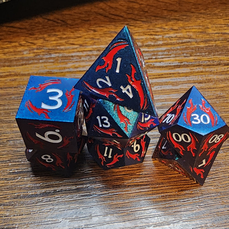 Blue metal dice with red dagger motifs