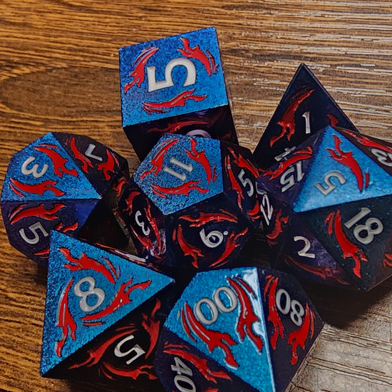 Close-up of blue metal dice with red daggers