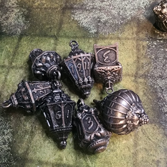 Seven-piece forest lantern metal dice set in copper finish
