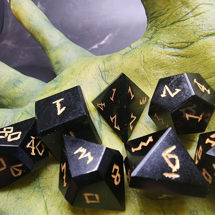 Angled detail of hand-finished Obsidian polyhedral dice