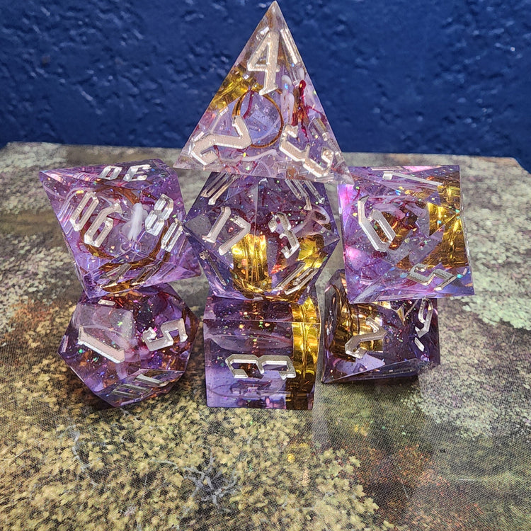 Stacked purple and gold ribbon dice photographed in ordinary lighting