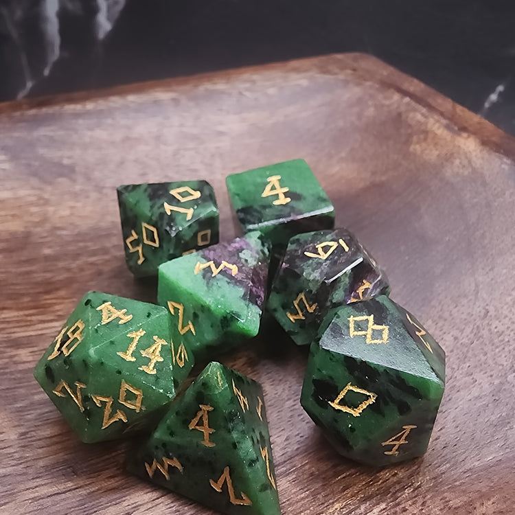 Seven-piece Ruby Zoisite dice set with green, violet-red and black stone patterns and gold-colored numbers