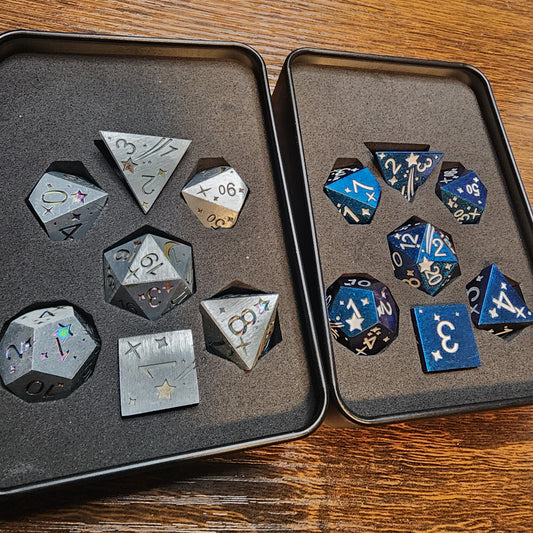 Both celestial metal dice sets in foam-lined tins